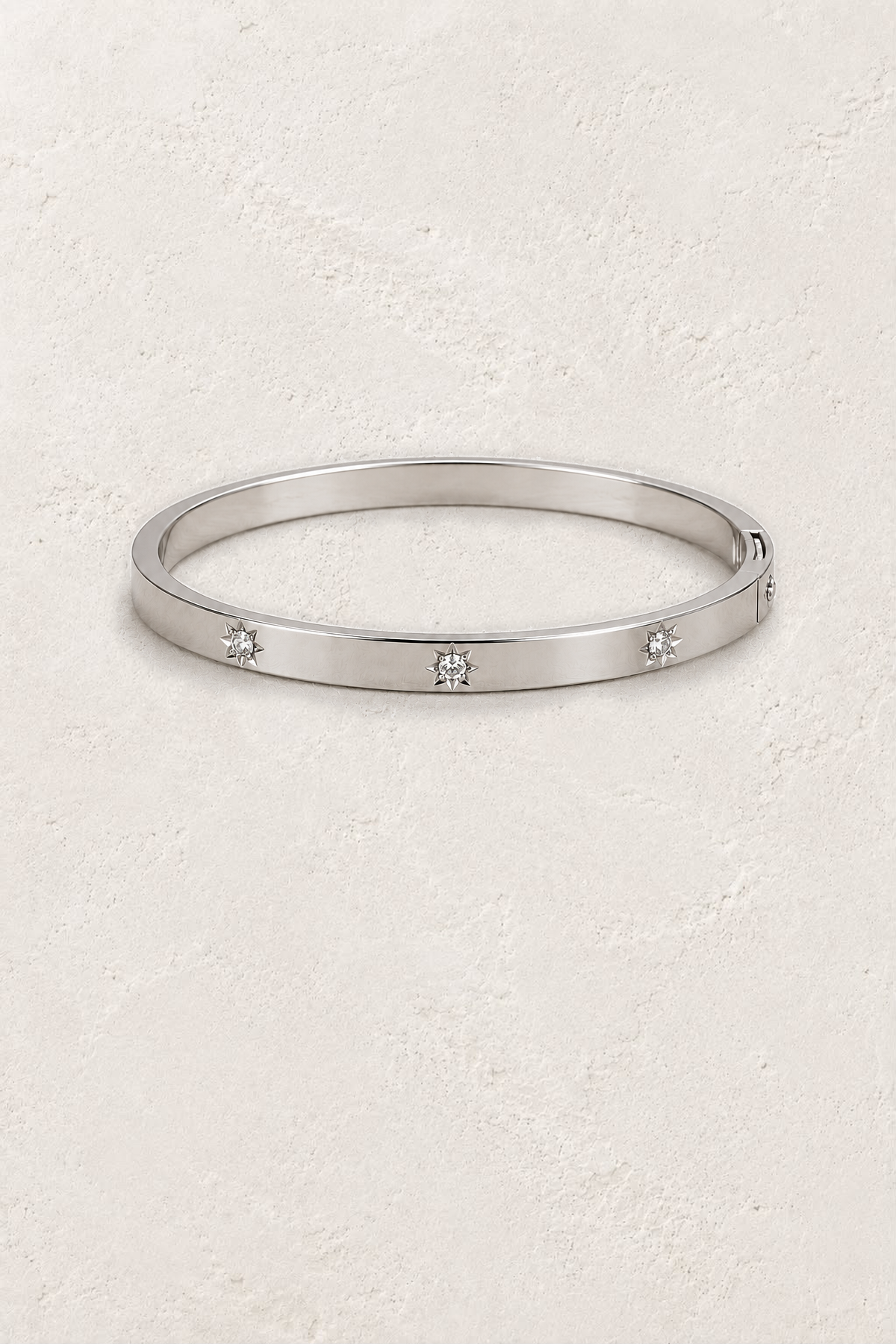 
                  
                    Aster Silver Diamond Motif Bangle on the reference plaster background
                  
                