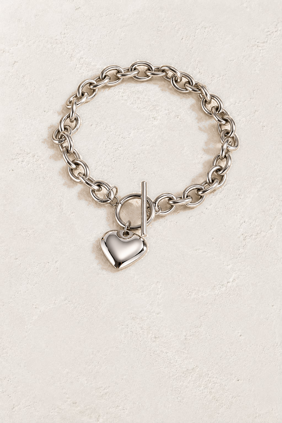 
                  
                    Amora Silver Heart Toggle Bracelet on the reference plaster background
                  
                
