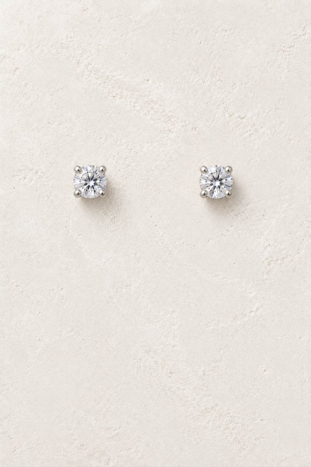 
                  
                    4mm CZ Clear Stud on cream plaster background
                  
                