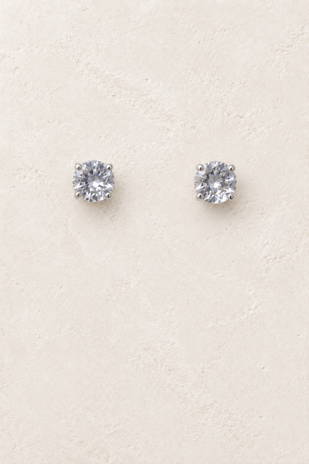 7mm CZ Clear Stud on cream plaster background