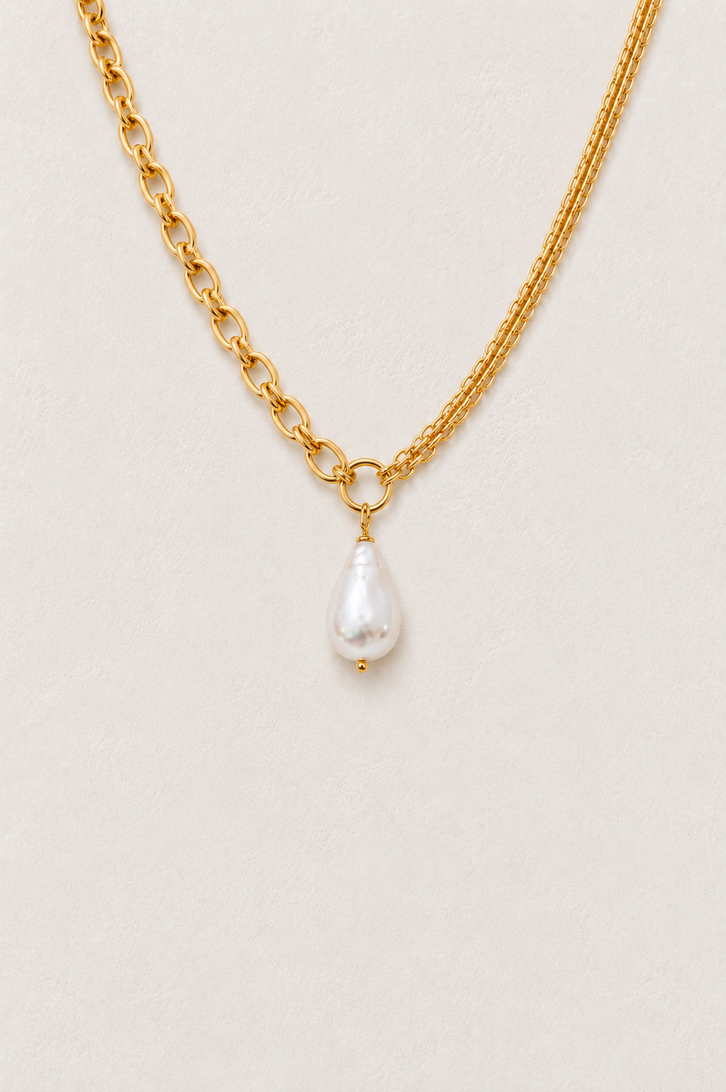 Luna Pearl Link Necklace in waterproof gold with a single freshwater pearl on a warm textured background