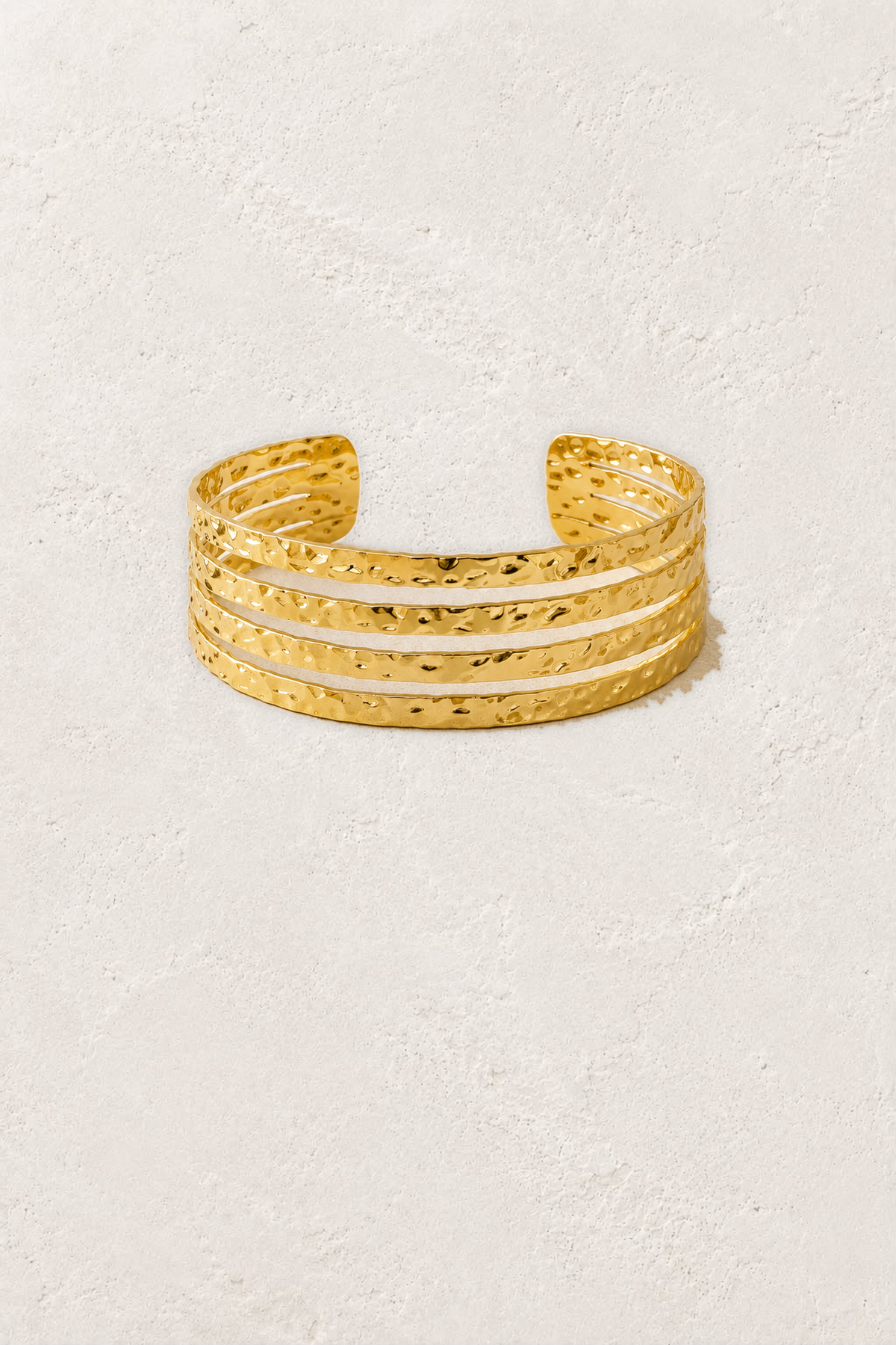 Aurora Textured Gold Bangle on the reference plaster background