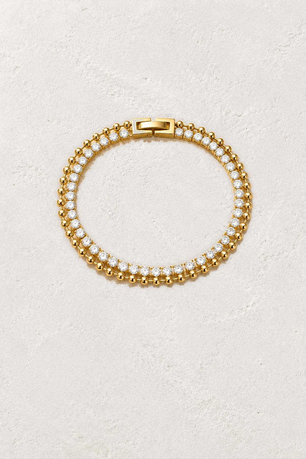 Aurora Crystal Beaded Gold Tennis Bracelet on the reference plaster background