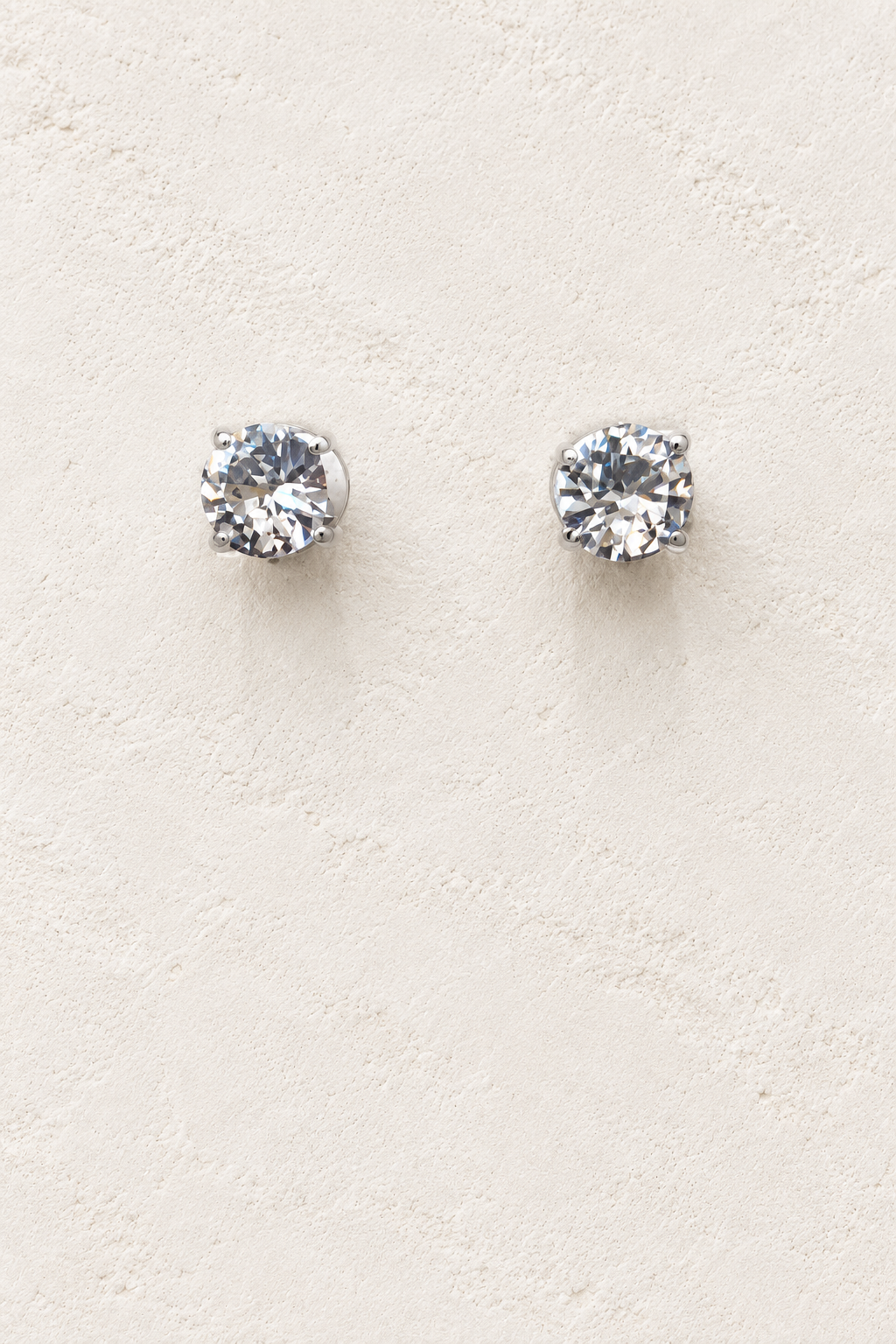 
                  
                    8mm CZ Clear Stud on cream plaster background
                  
                