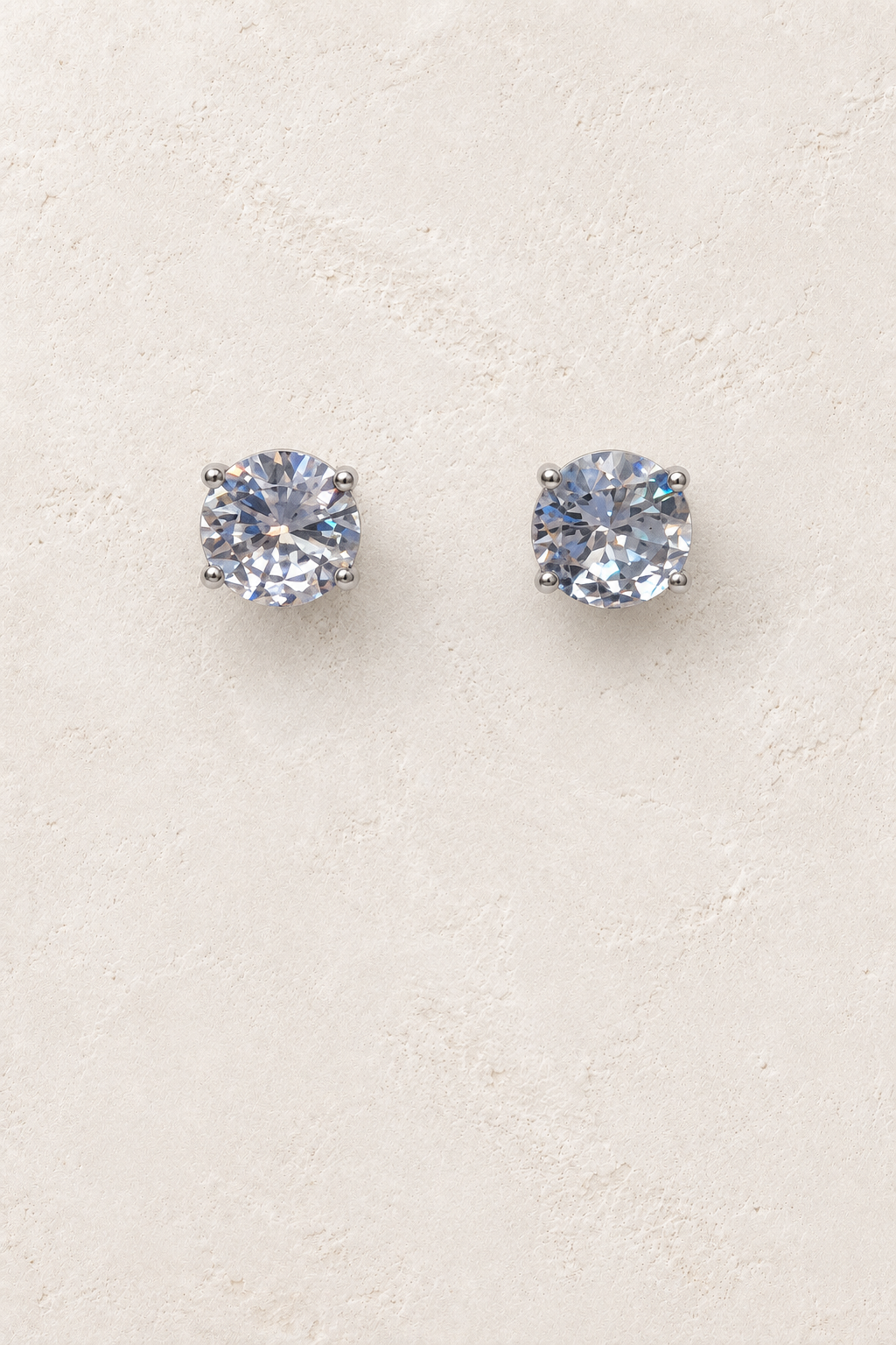 
                  
                    9mm CZ Clear Stud on cream plaster background
                  
                