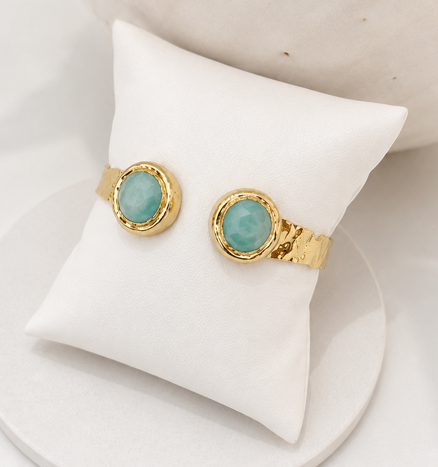 
                  
                    Gold plated and Amazonite hammered open cuff bangle on white pillow display 
                  
                