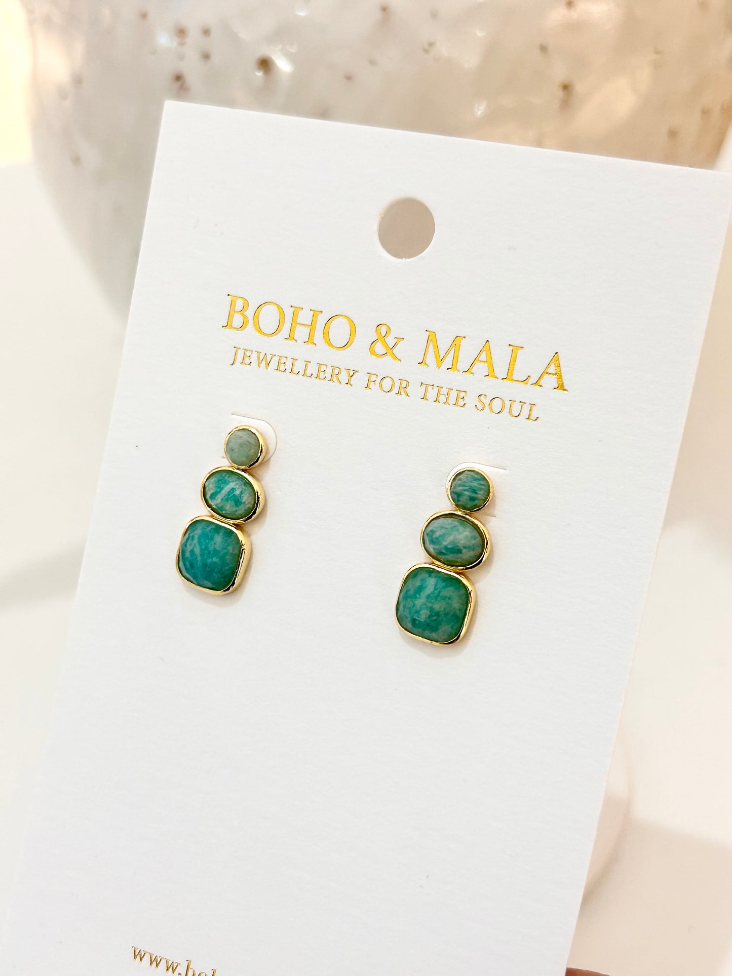 
                  
                    Pair of anmazonite earrings on a 'Boho & Mala' branded card.
                  
                