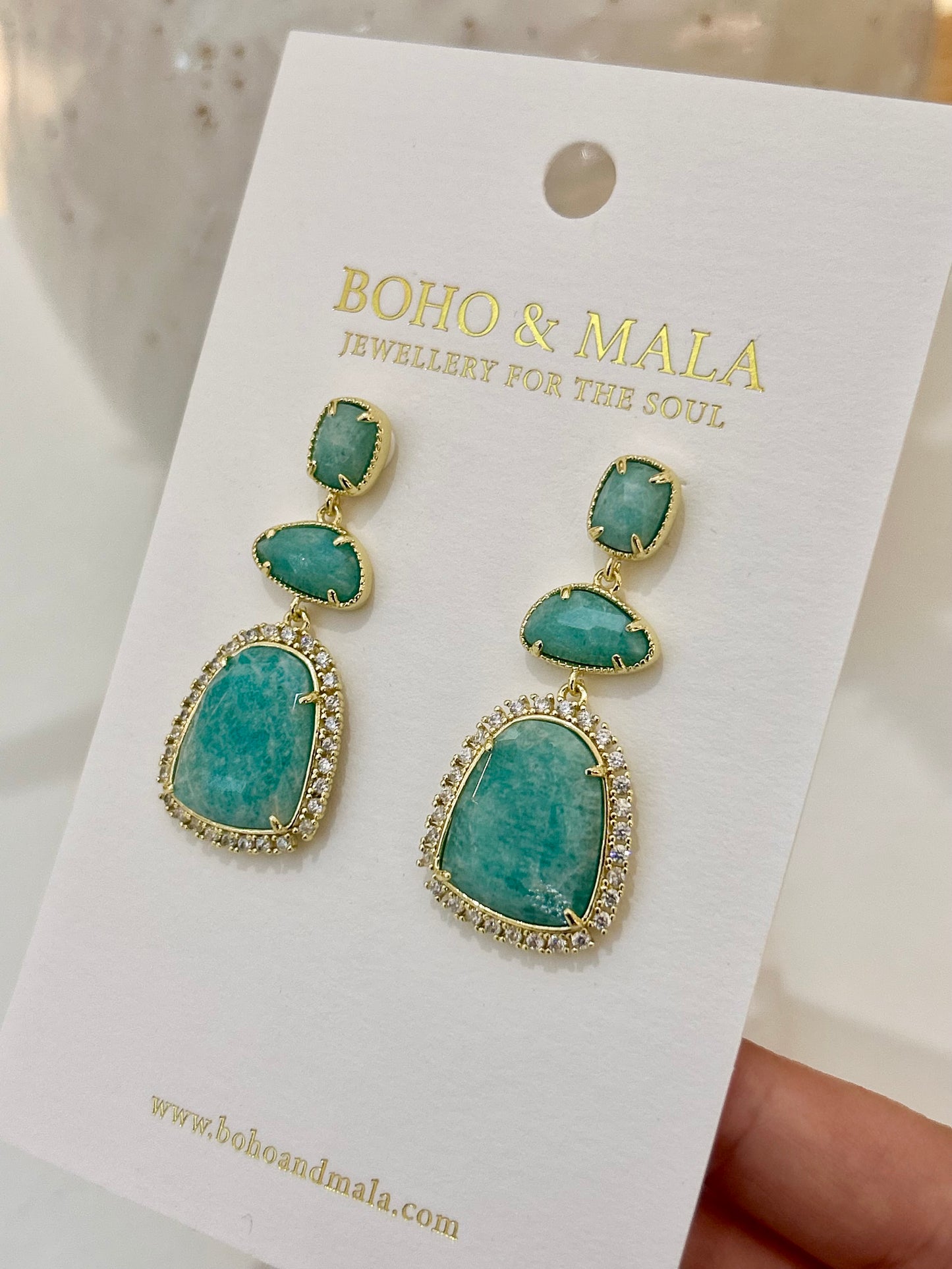 
                  
                    Amazonite earrings on a 'Boho & Mala' branded card.
                  
                