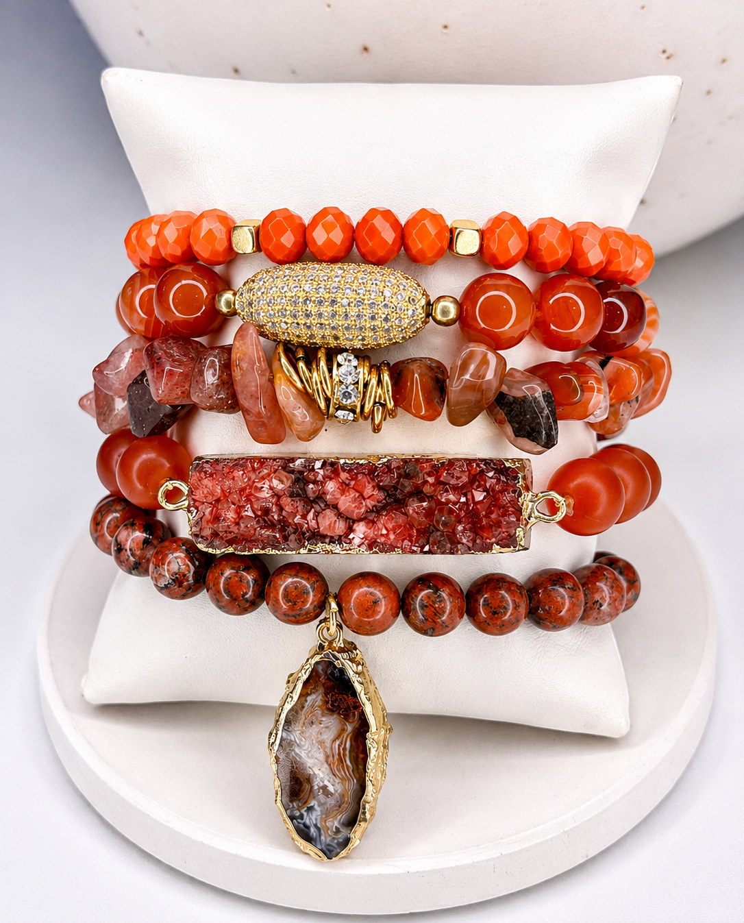 
                  
                    Stack of colorful beaded bracelets on a white surface
                  
                