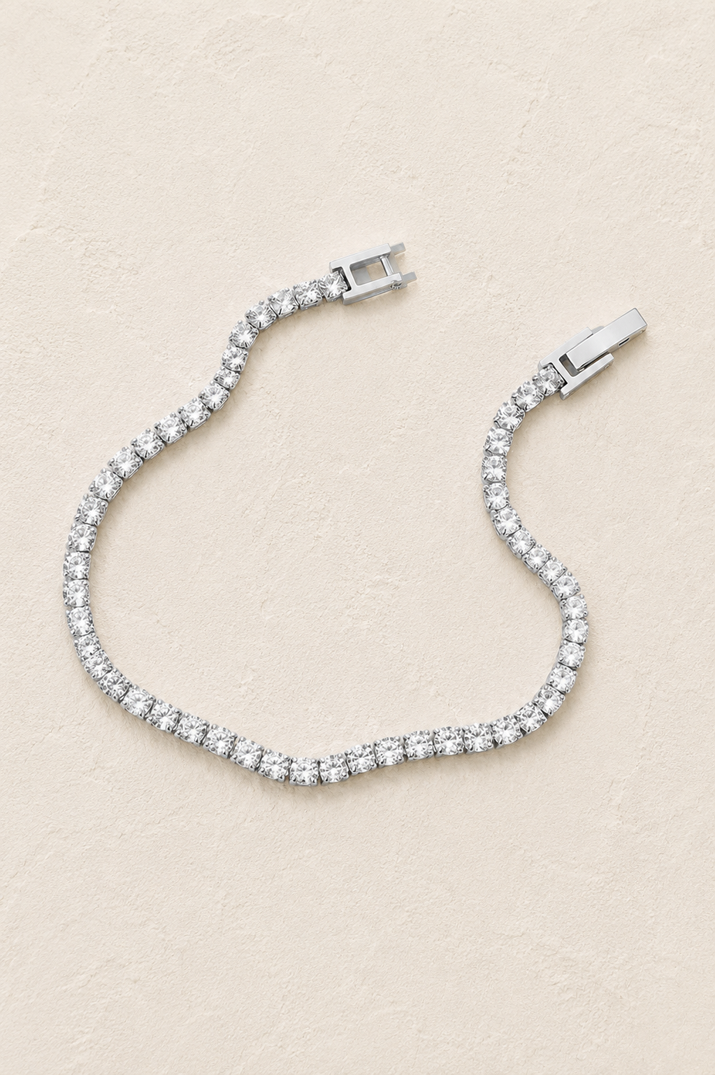Silver crystal tennis bracelet on ivory textured background