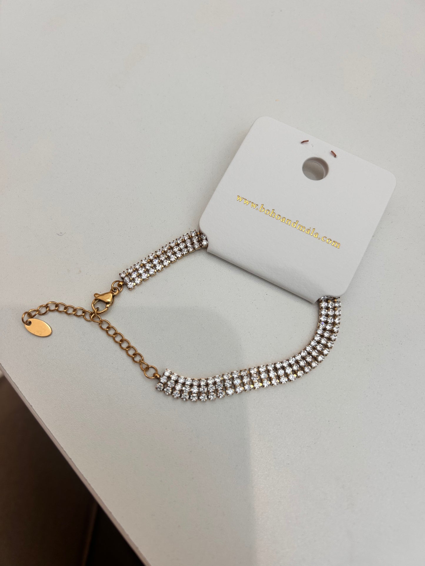 
                  
                    Luciana Gold Triple Row Crystal Tennis Bracelet original product detail photograph
                  
                