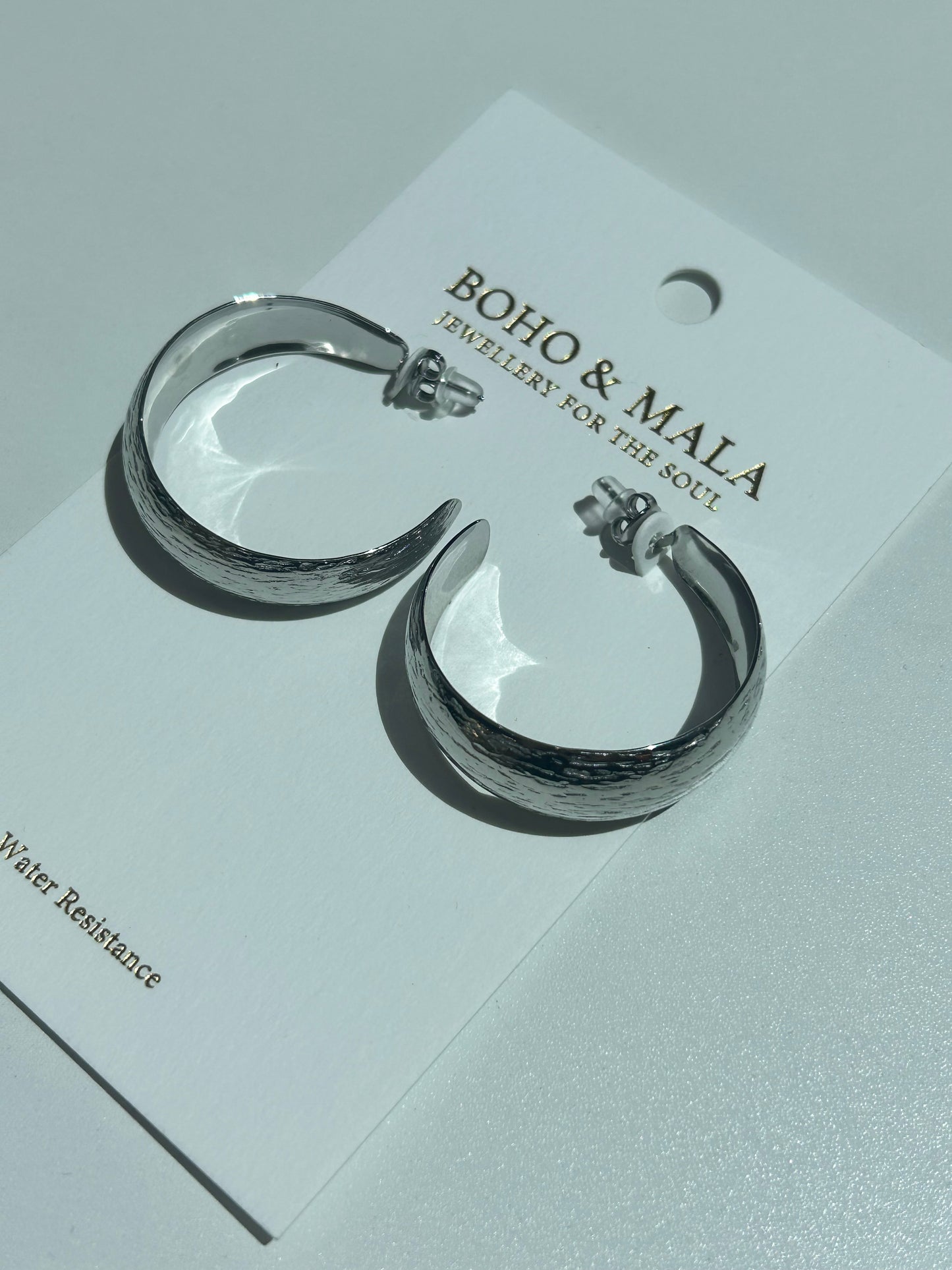 
                  
                    Zahara Silver Crescent Hoop Earrings
                  
                