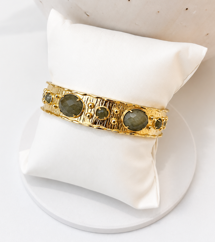 
                  
                    natural labradorite stone cuff bangle on white pillow display
                  
                