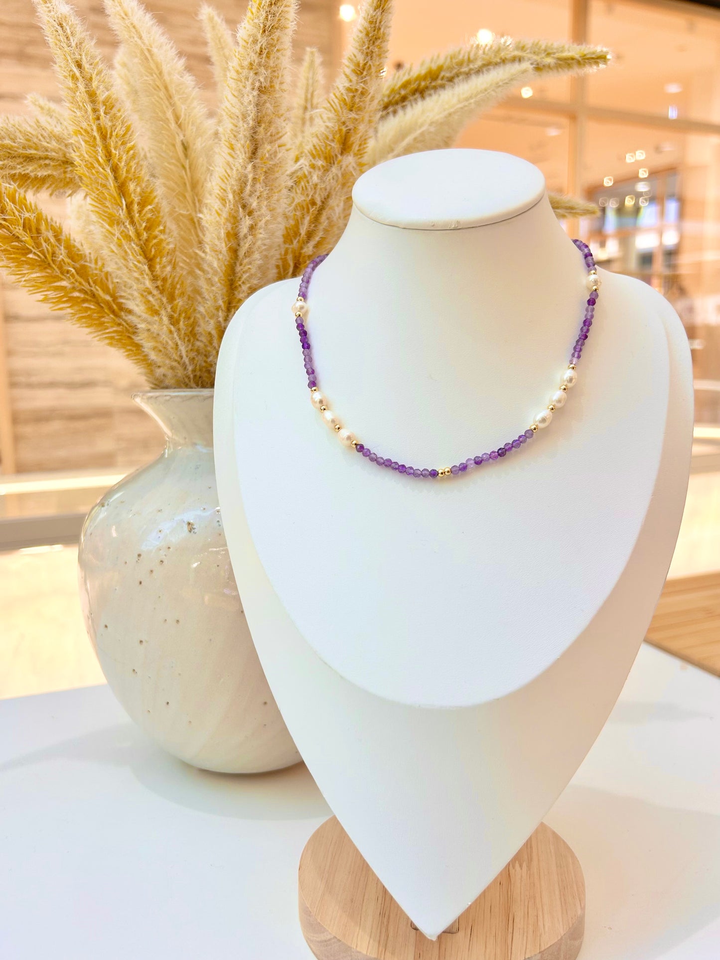 
                  
                    beaded amethyst necklace with freshwater pearls on a white jewellery stand bust
                  
                