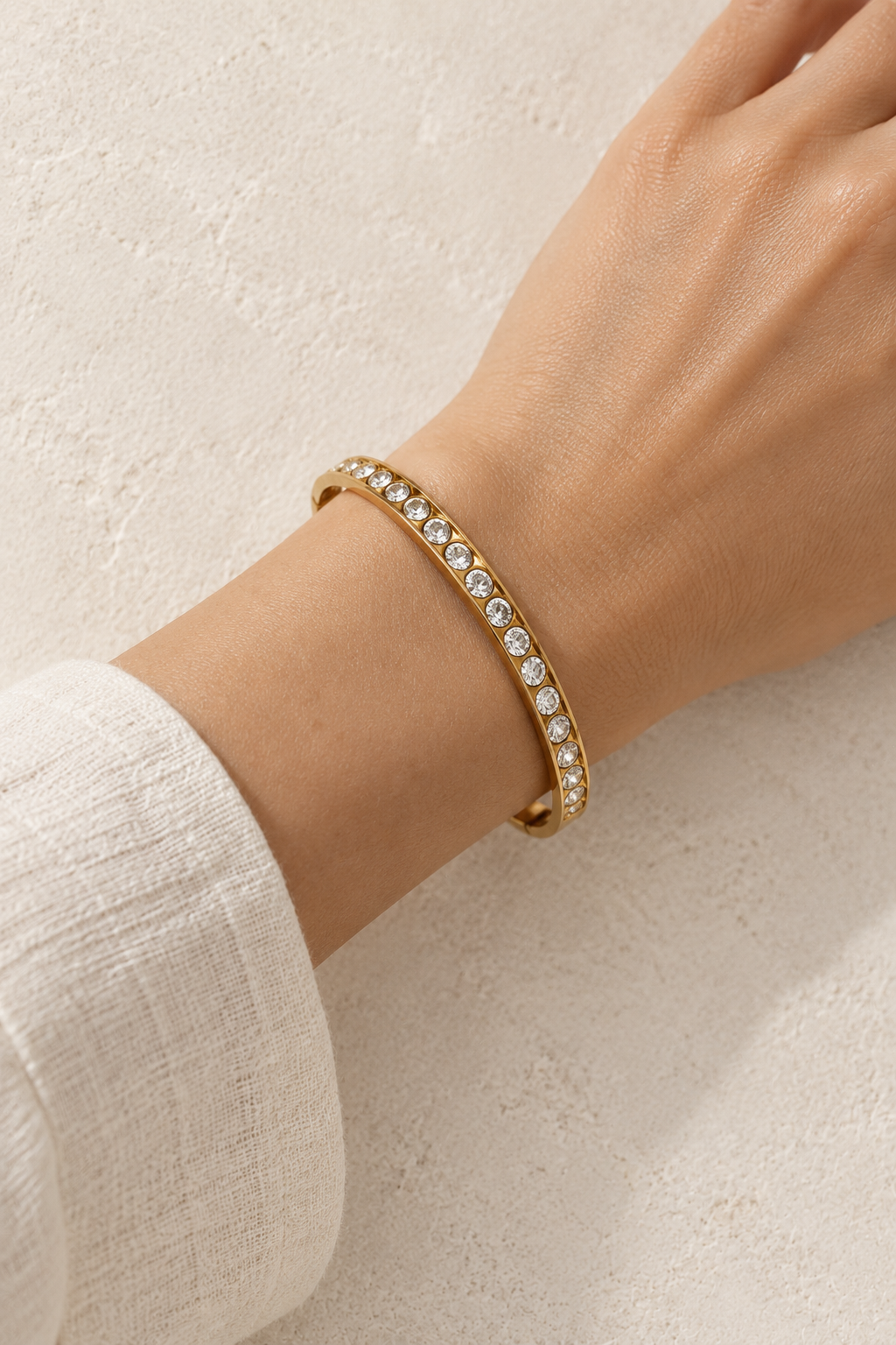 
                  
                    Model wearing Amara Gold Round Crystal Bangle
                  
                