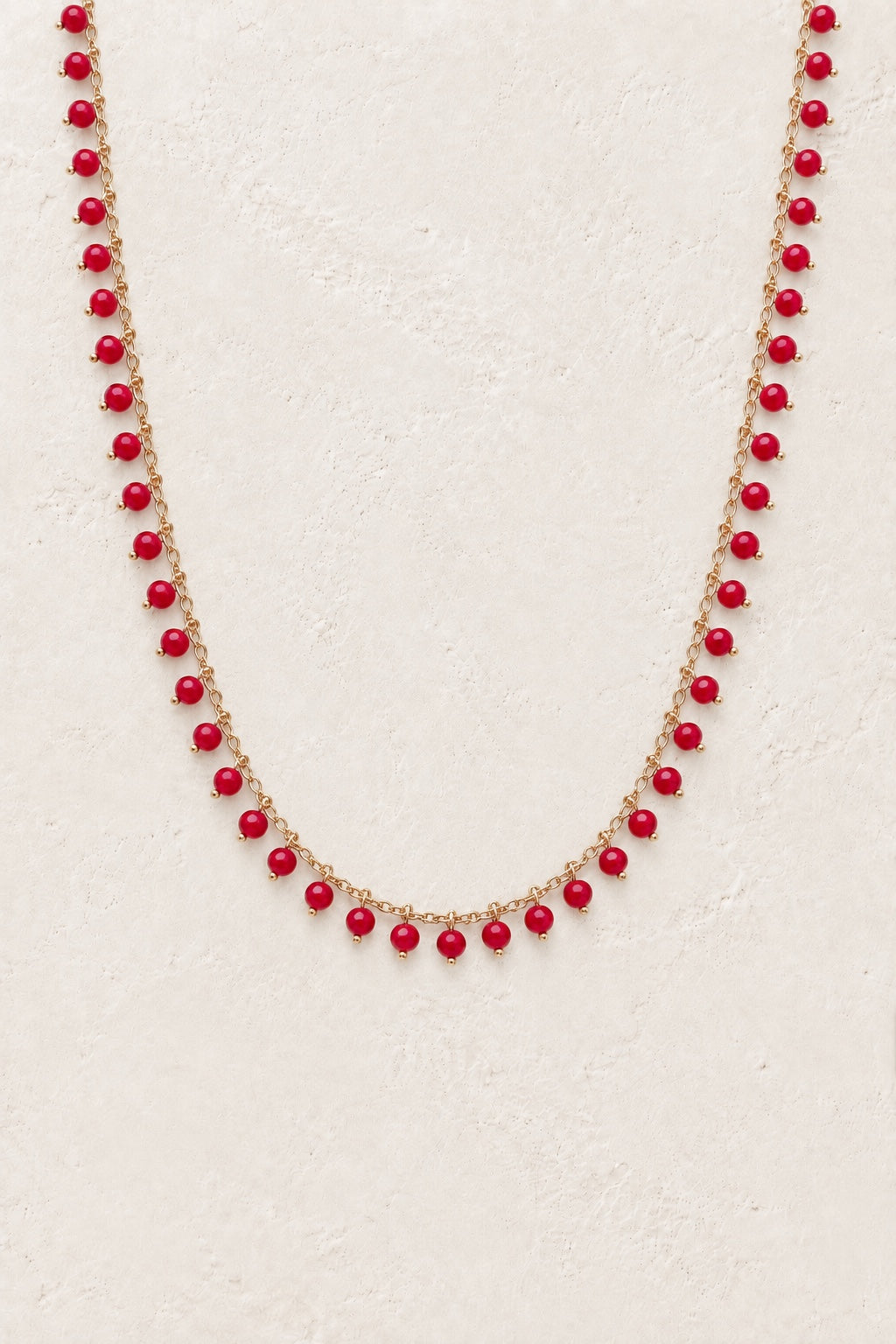 
                  
                    Ariella Red Jade gemstone drop necklace on a light background
                  
                