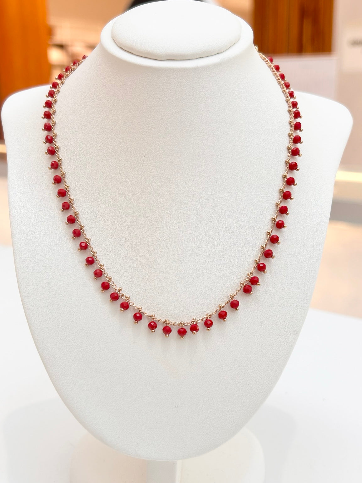 
                  
                    Ariella Red Jade gemstone drop necklace displayed on a jewellery bust
                  
                