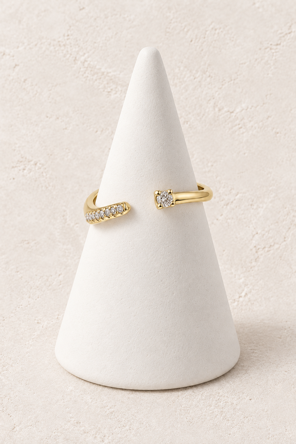 Aster Crystal Tip Ring on a white display cone against a warm textured background