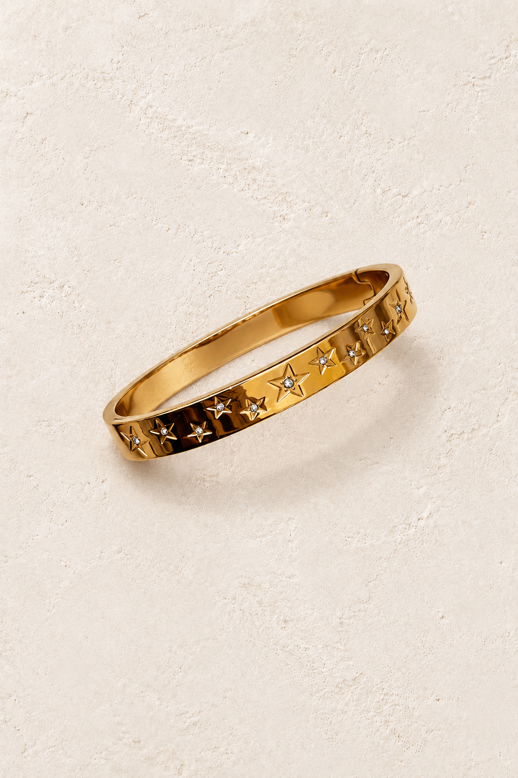 
                  
                    Astra Gold Celestial Bangle on cream beige textured background
                  
                