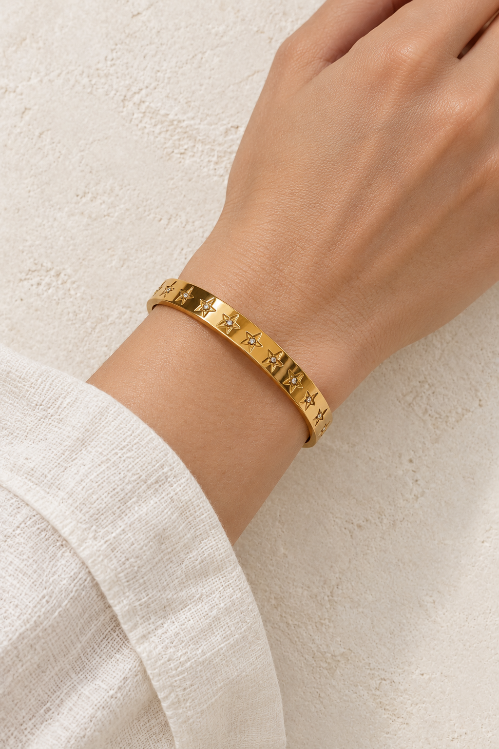 
                  
                    Model wearing Astra Gold Celestial Bangle
                  
                