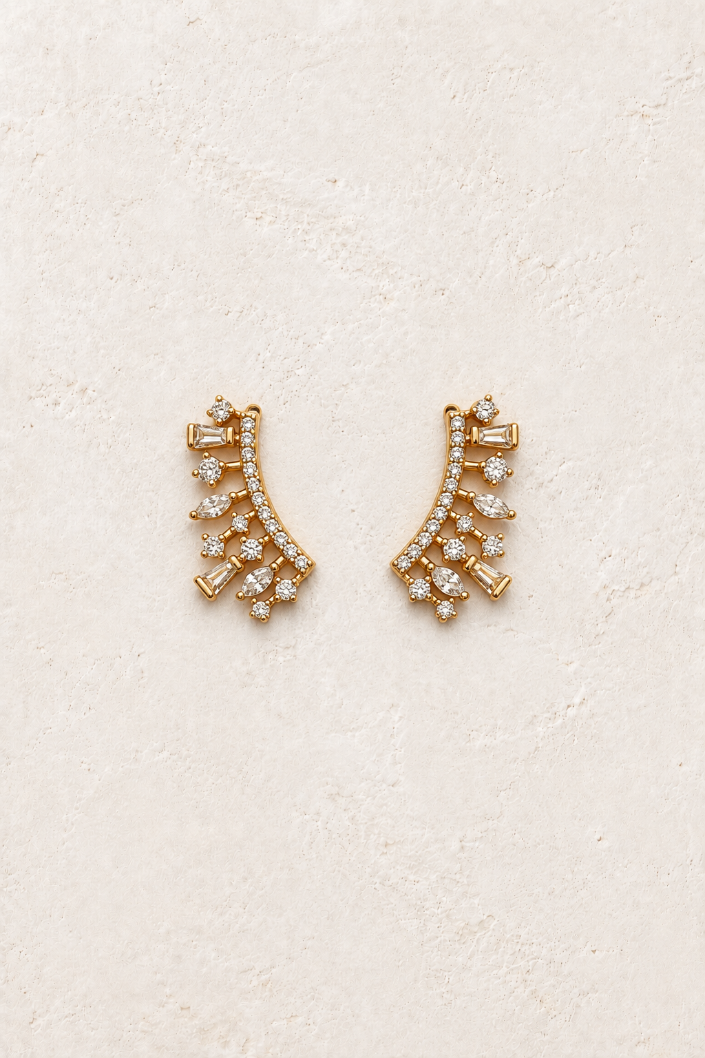 Aurette Crystal Vine Ear Climbers on warm ivory textured background