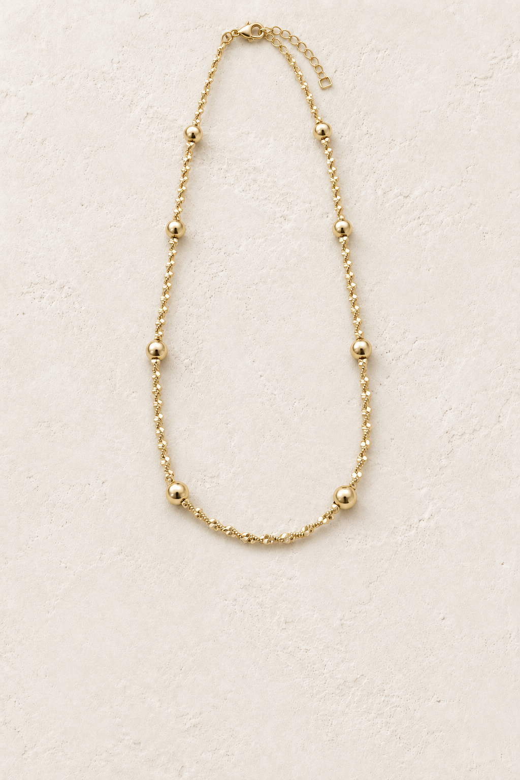 Aurette Gold Twisted Dotted Chain Necklace on cream plaster – Boho & Mala jewellery
