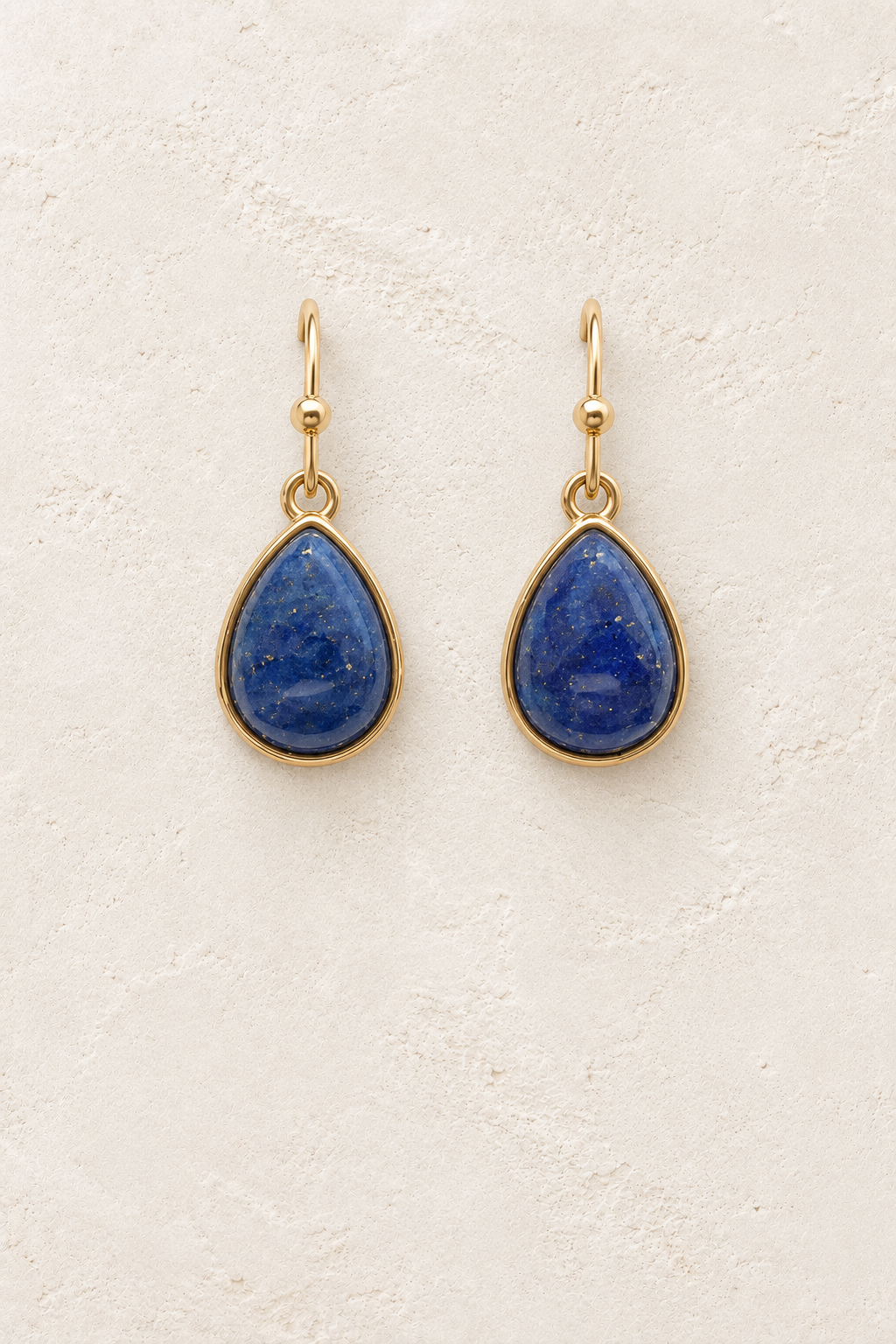 Aviana Lapis Lazuli Teardrop Earrings on cream plaster background