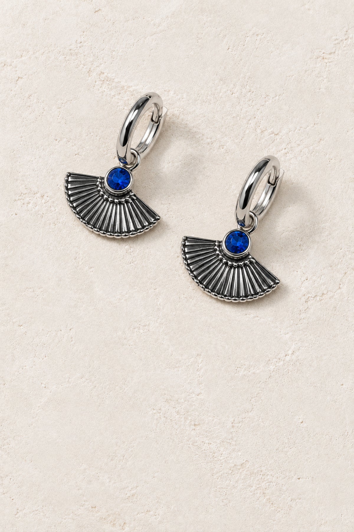Azura Silver Blue Fan Drop Earrings on warm ivory plaster