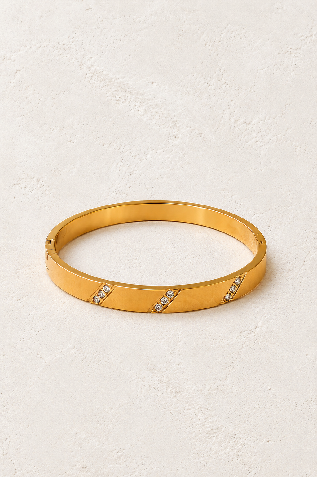 Lucienne Brushed Gold Diagonal Crystal Bangle on Francesca's supplied original hero background