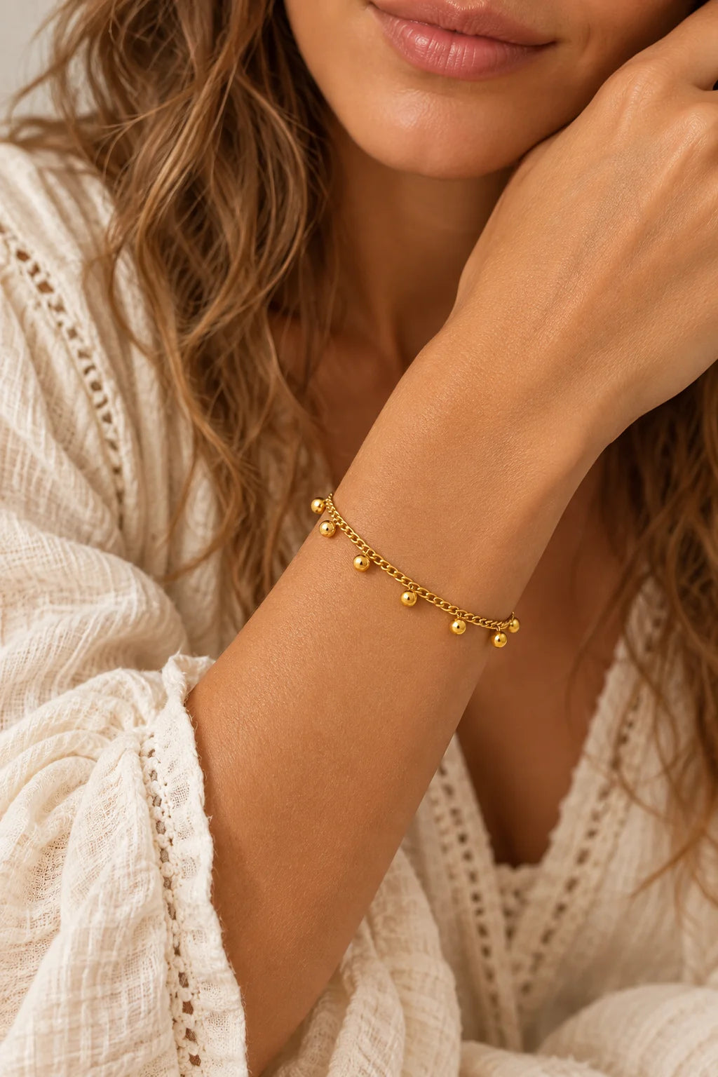 
                  
                    Dalia Gold Bead Charm Bracelet worn on a model's wrist
                  
                