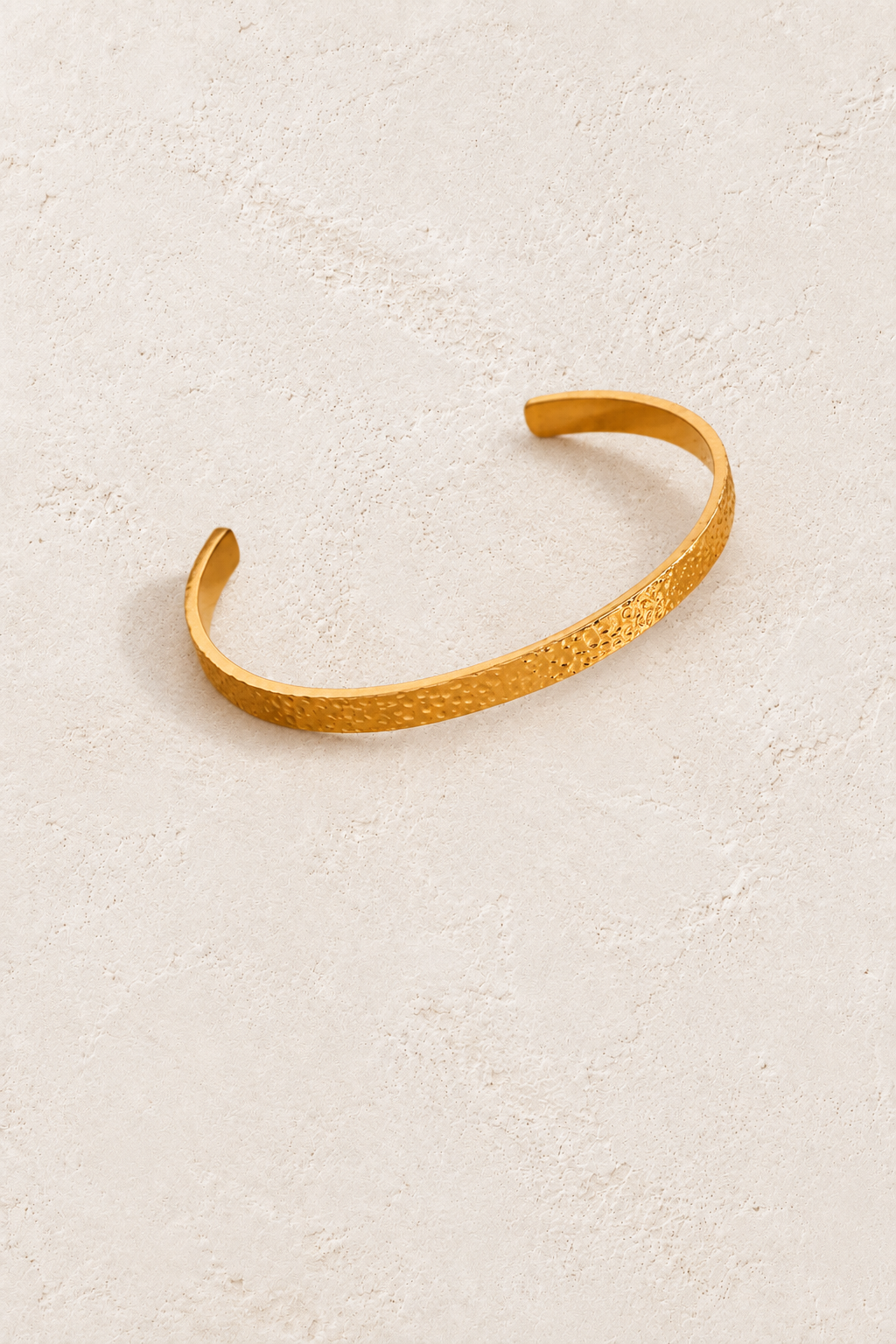Classic Textured Gold Cuff on cream beige textured background