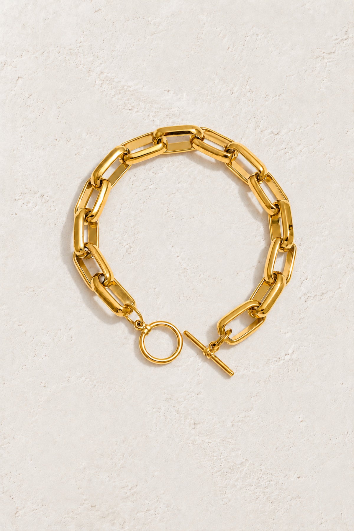 
                  
                    Bold Link Gold Toggle Bracelet on the approved Boho & Mala ivory plaster background
                  
                