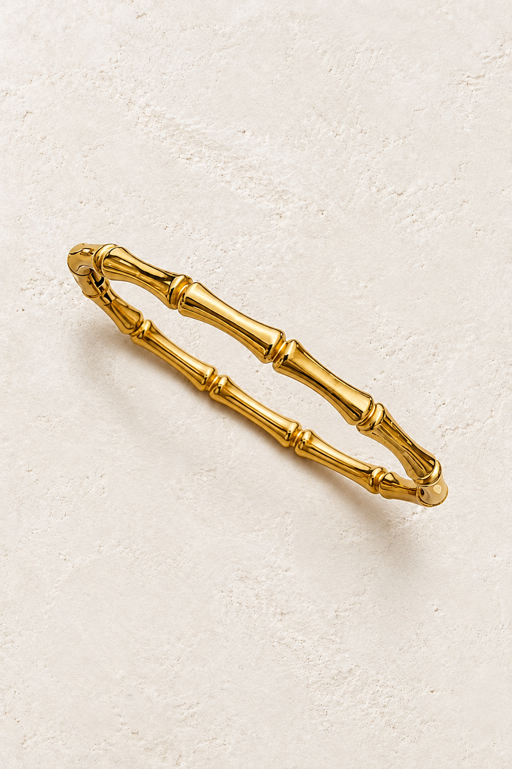 
                  
                    Gold Bamboo Style Bangle | Waterproof on ivory textured background
                  
                
