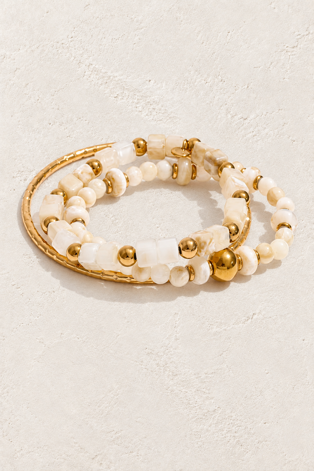 Ivory Glow Beaded Bracelet Stack on ivory textured background