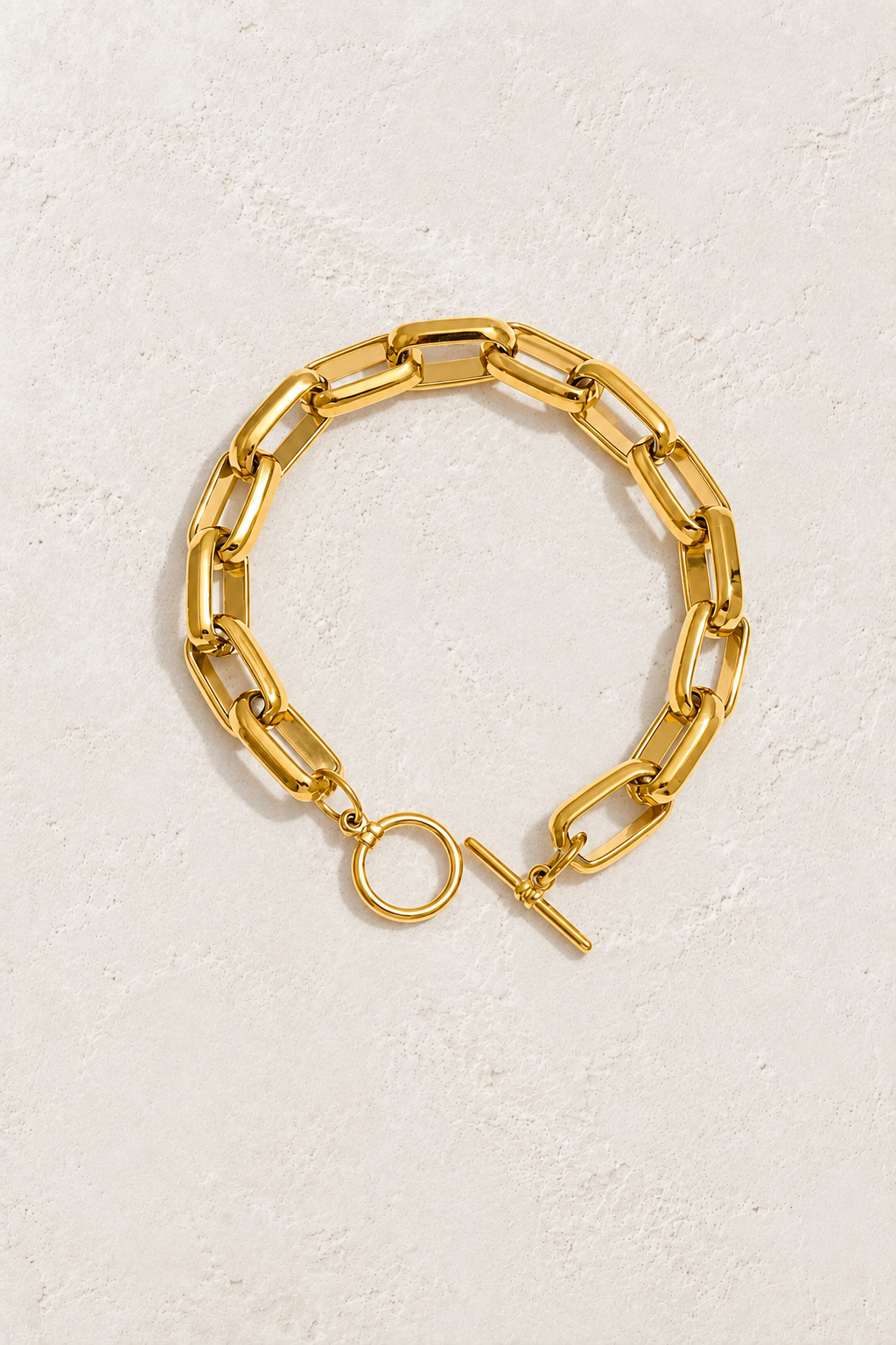 
                  
                    Bold Link Gold Toggle Bracelet on ivory textured background
                  
                