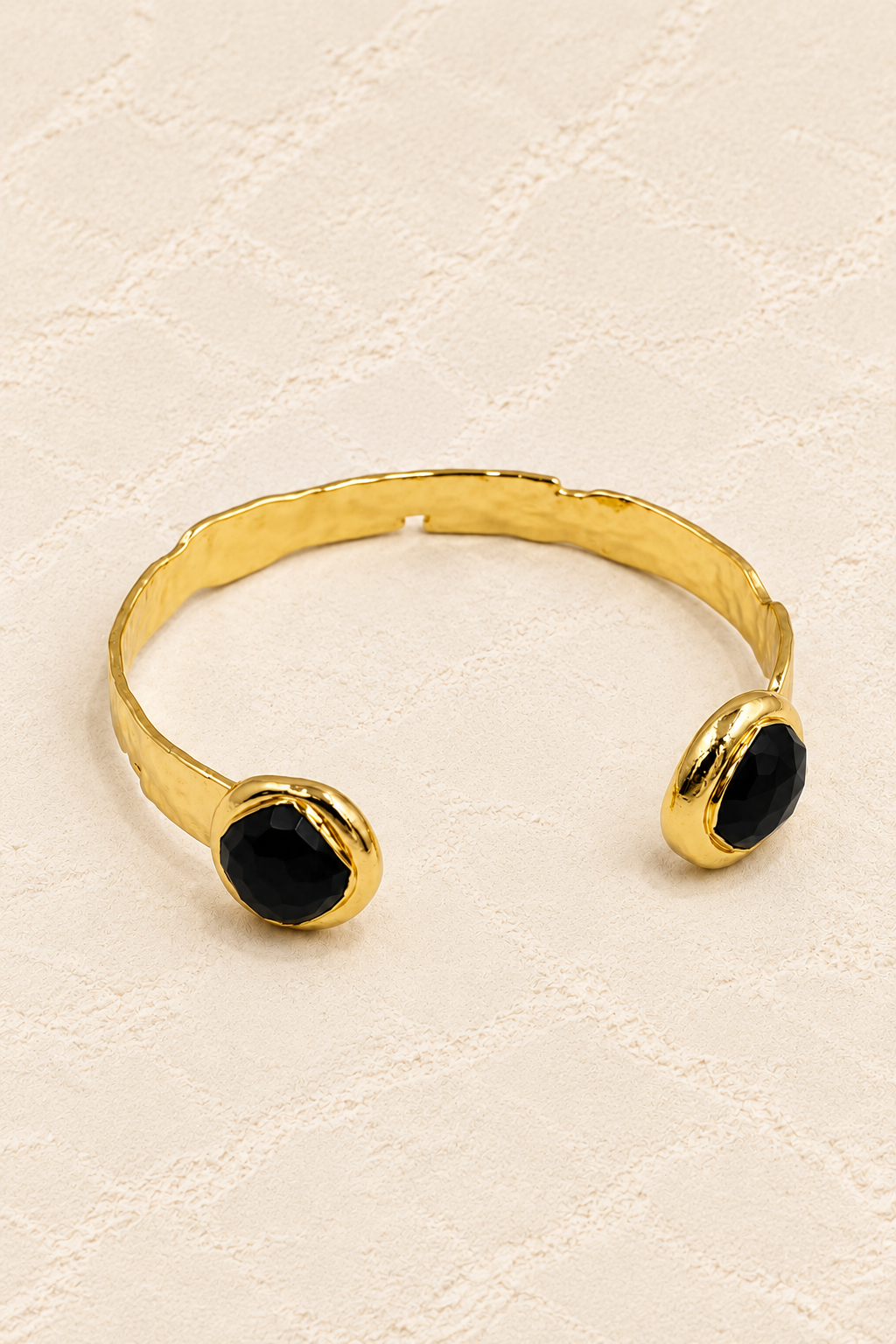 
                  
                    Black Obsidian Isla Cuff Bracelet on ivory plaster, tall product cover
                  
                