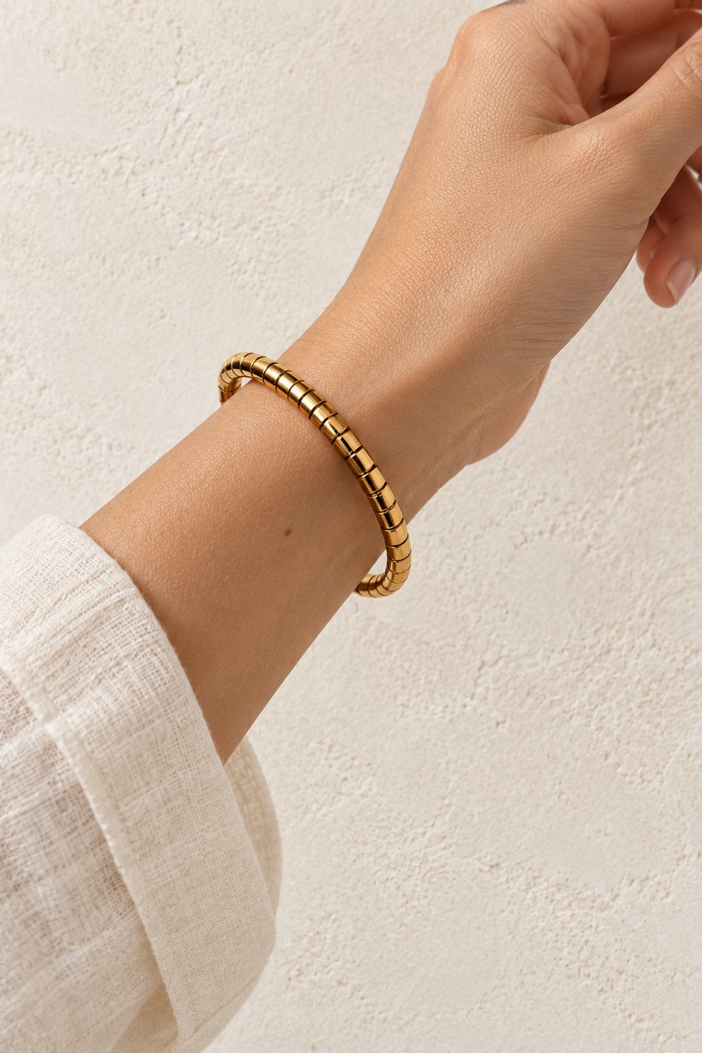 
                  
                    Model wearing Brisa Midi Oval Gold Ribbed Bangle
                  
                