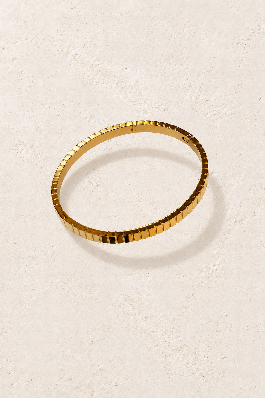 
                  
                    Brisa Mini Gold Ribbed Bangle on cream beige textured background
                  
                