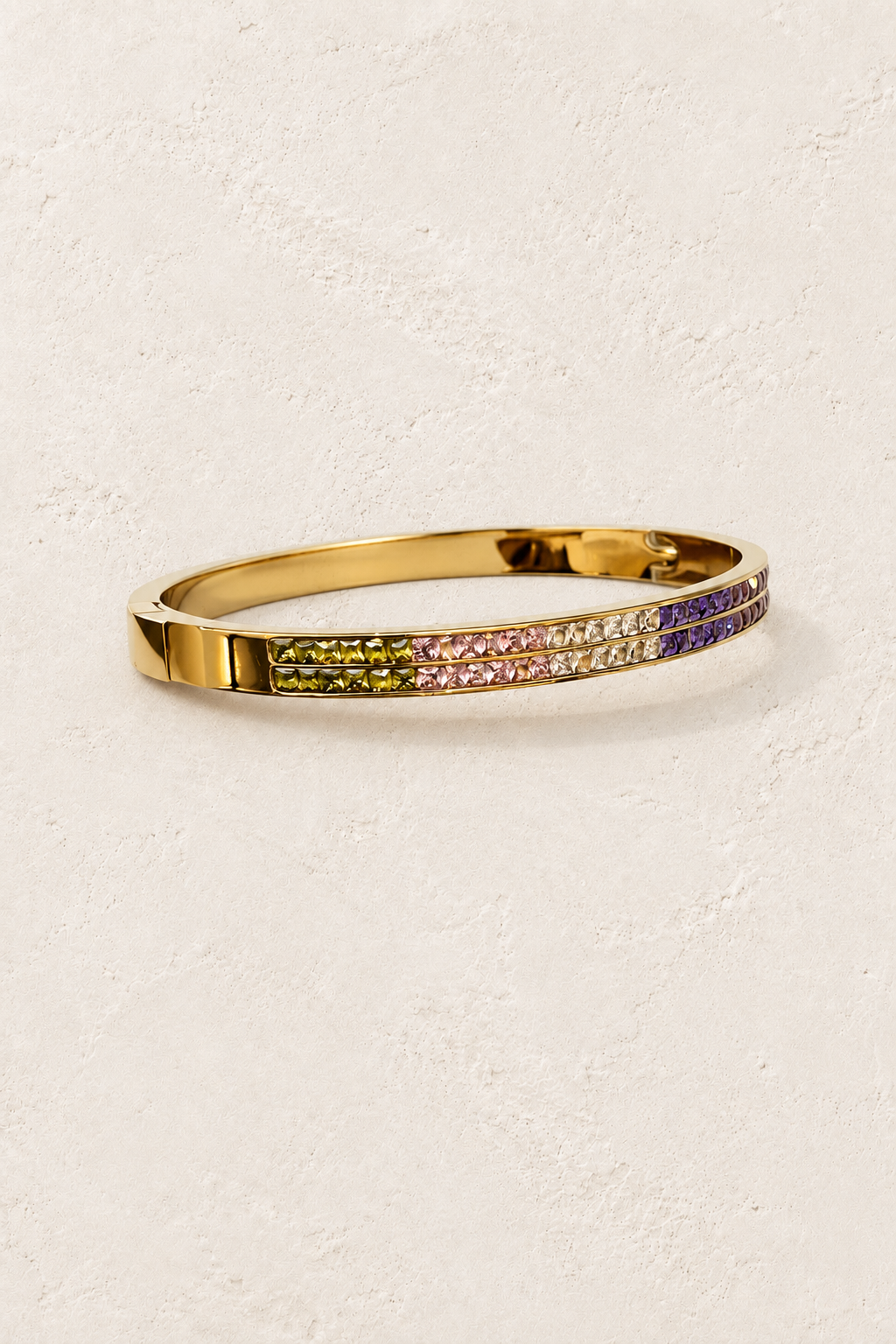 
                  
                    Calista Gold Multicolour Pavé Bangle on cream beige textured background
                  
                