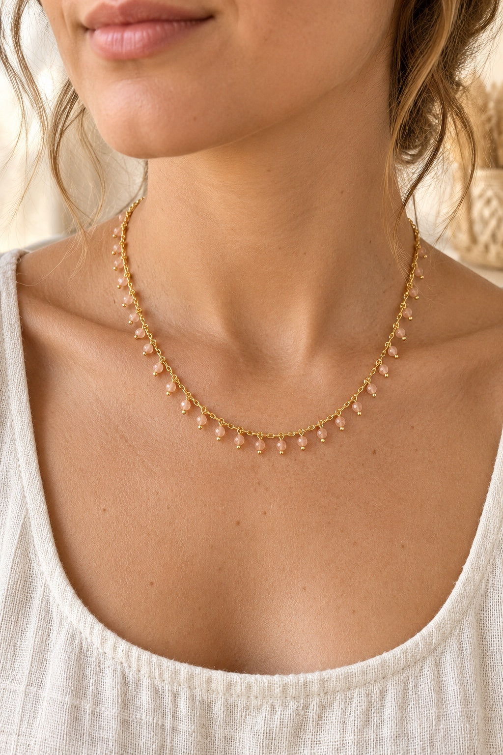 Model wearing the Calista Sunstone gemstone drop necklace
