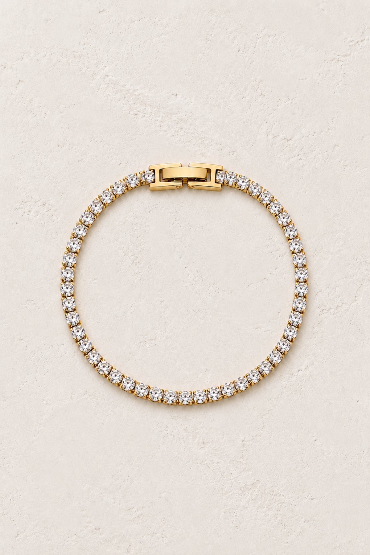 Celeste Classic Gold Tennis Bracelet on Boho & Mala's ivory plaster background