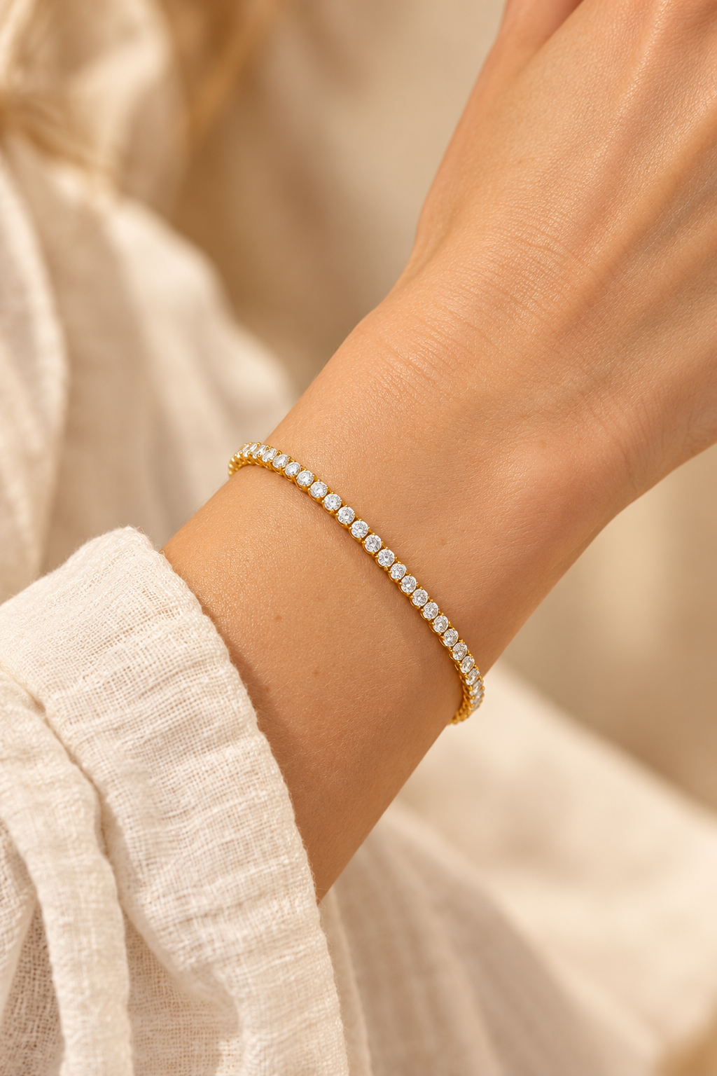 Celeste Gold Crystal Tennis Bracelet worn on a model's wrist
