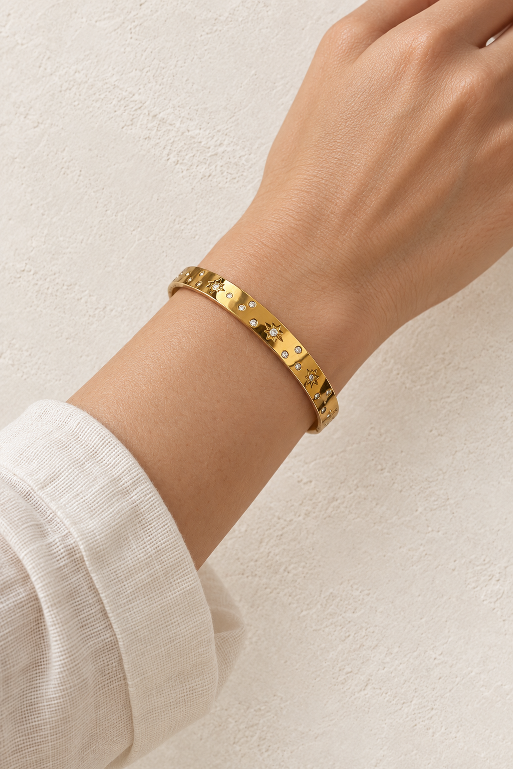 
                  
                    Model wearing Celestra Gold Starburst Bangle
                  
                