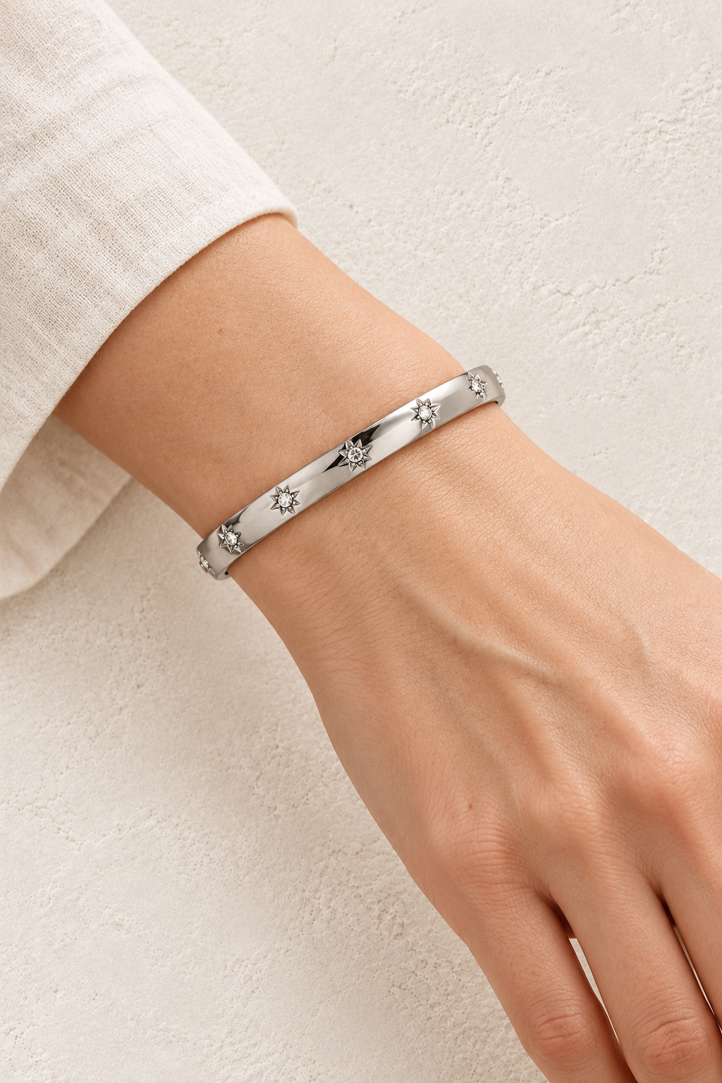 
                  
                    Model wearing Celestia Silver Starburst Bangle
                  
                
