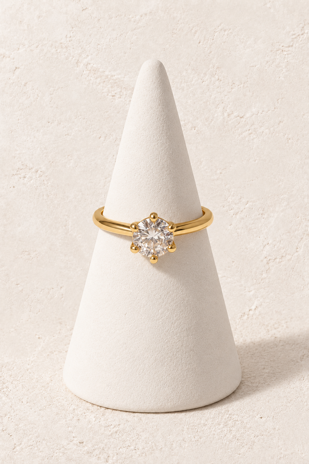 Celestial Glow Ring on a white display cone against a warm textured background