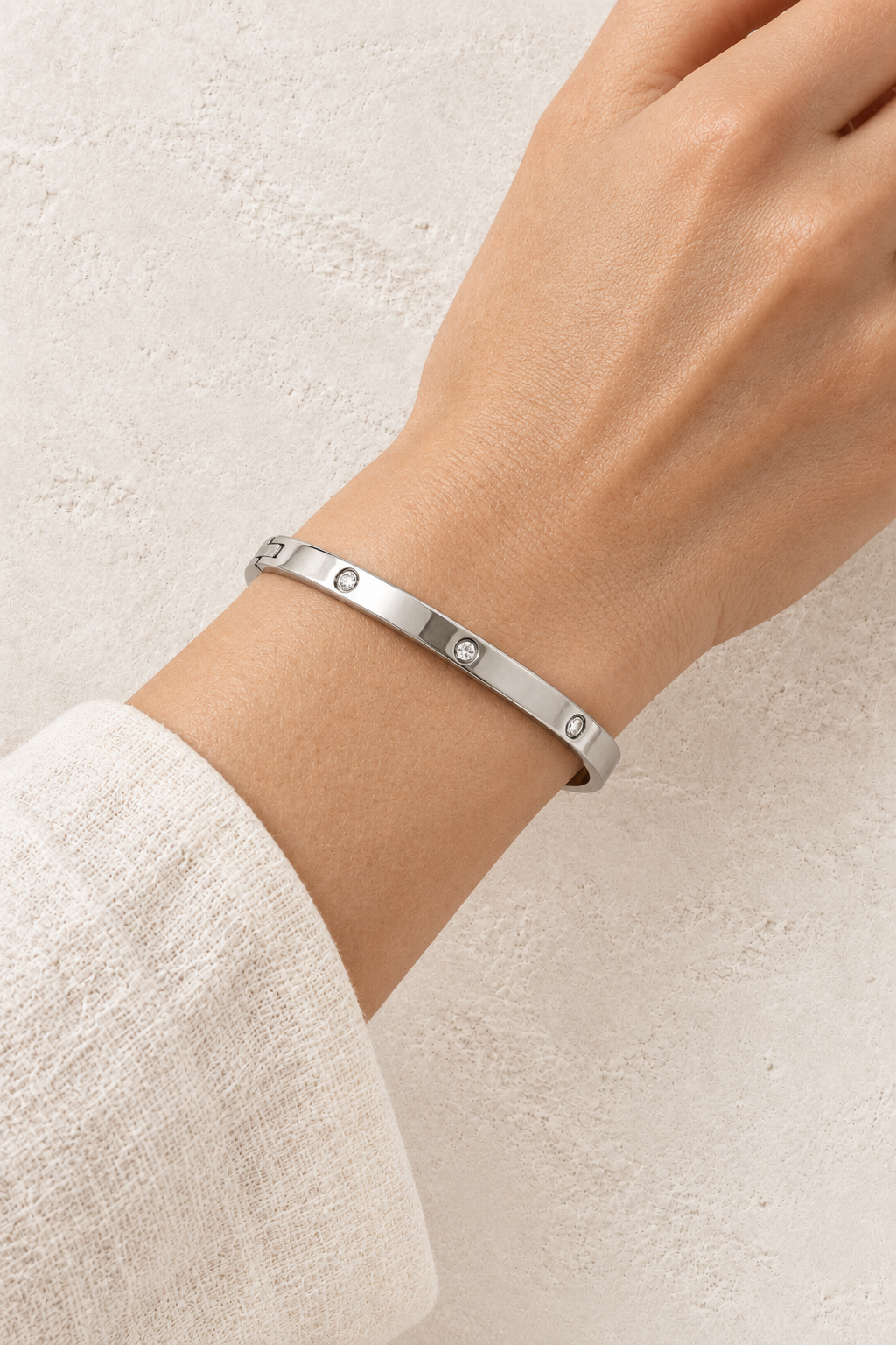 
                  
                    Model wearing Celine Silver Scattered Crystal Bangle
                  
                