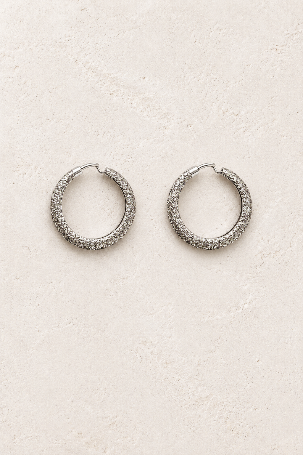
                  
                    Cielle Silver Shimmer Hoop Earrings on warm ivory plaster
                  
                