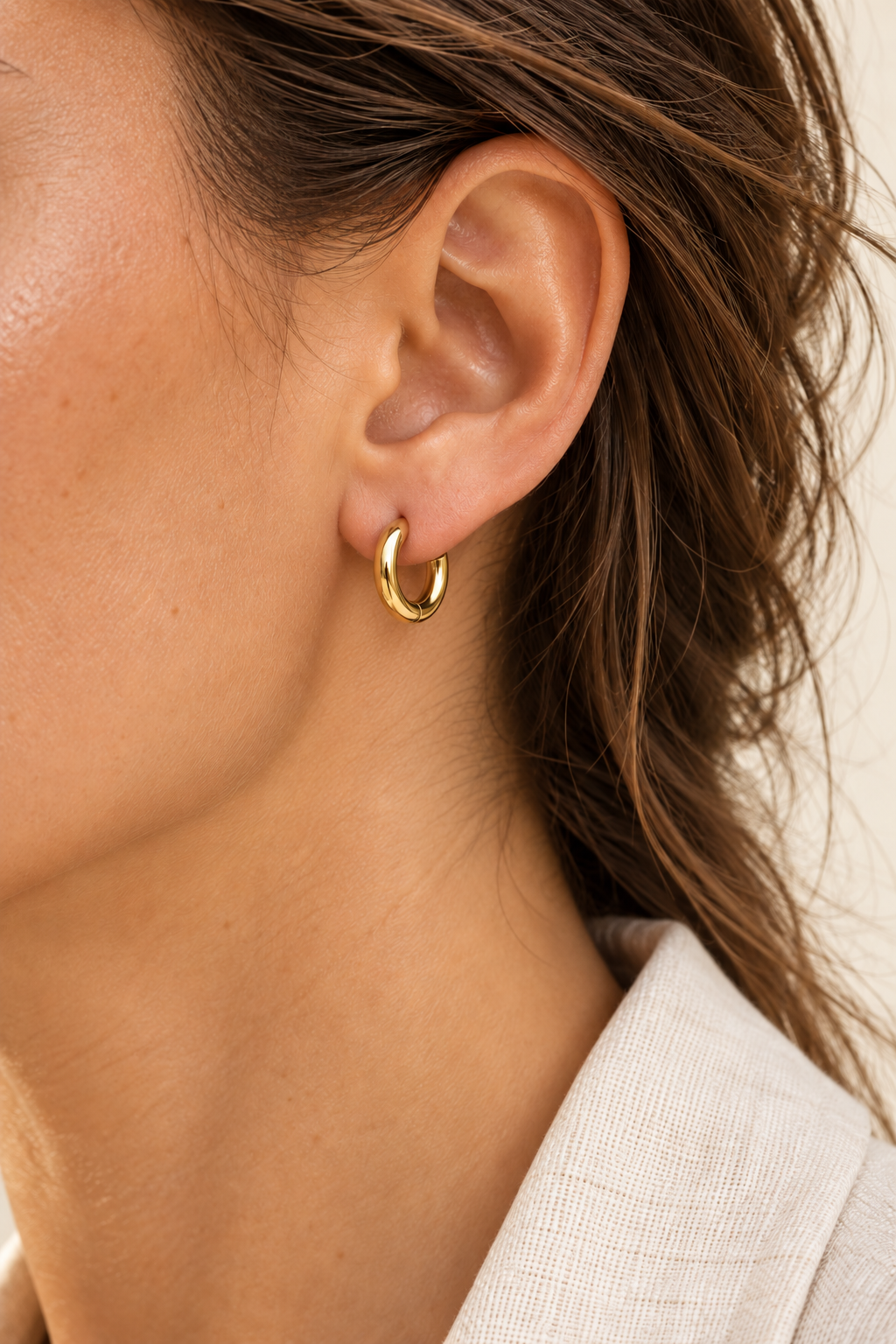 Model wearing Gold 11mm Classic Waterproof Hoop Earrings