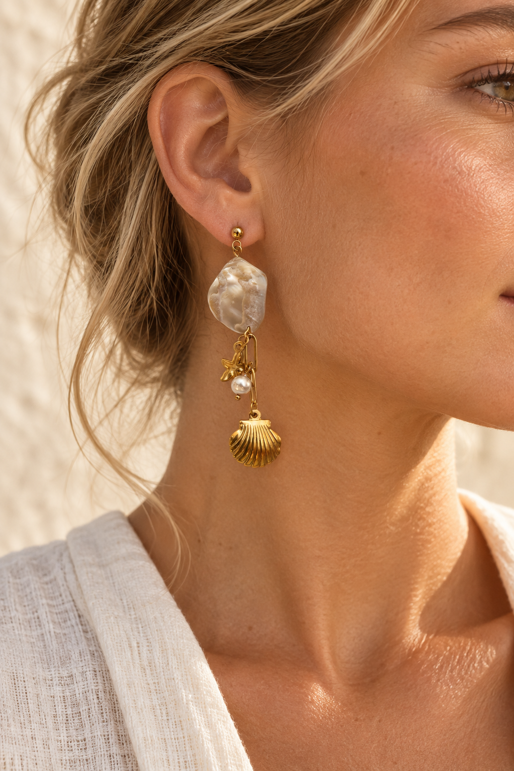Model wearing Coraline shell and ocean charm earring