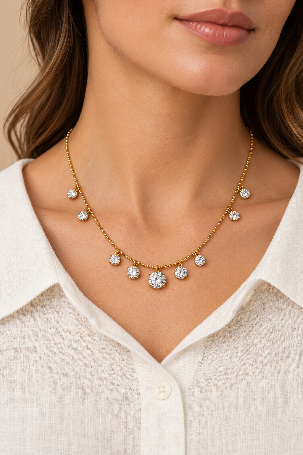 Cubic Zirconia Gold Necklace with nine clear dangling crystals worn on a model